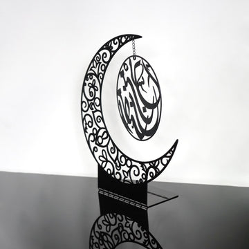 Siyah metal hilal masa dekoru, zincirle asılı Ramazan Kerim yazılı daire, yandan stüdyo çekimi