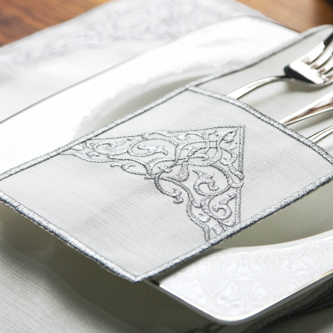 islamicwallart tasarimi olan bu sik sofrada beyaz kumas uzerine gumus rengi nakis islemeli servis cebi icerisinde catal bicak ve kasik takimi bulunmaktadir