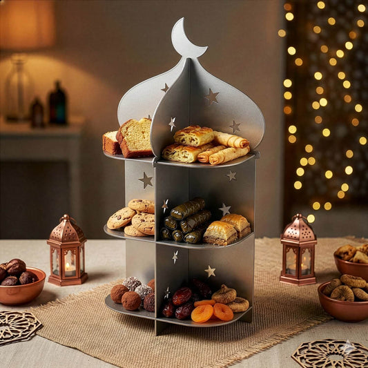Gümüş renkli 3 katlı metal minare sunum standı, ikramlarla dolu ve fenerlerin önünde